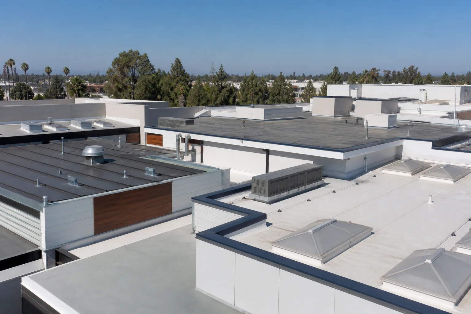 Modern LA building with a mix of roofing styles under a blue sky.